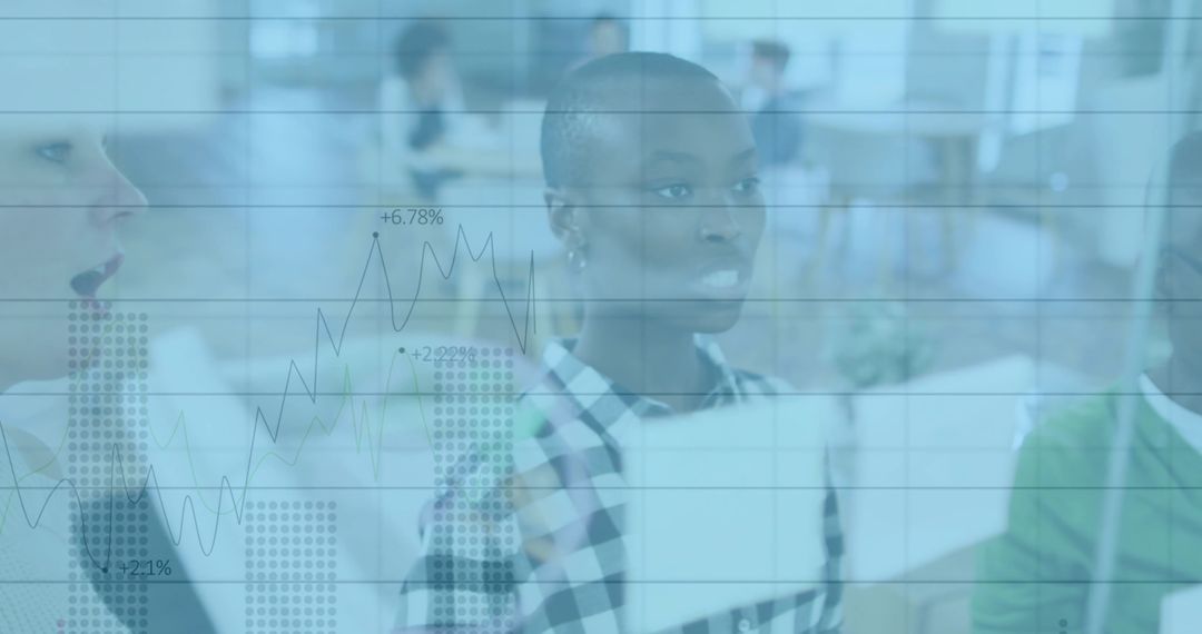 Team Collaborating on Data Analysis with Overlaid Graphs