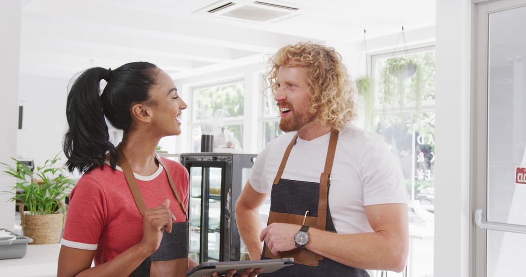 Diverse Baristas Discussing Business Strategies in Cafe