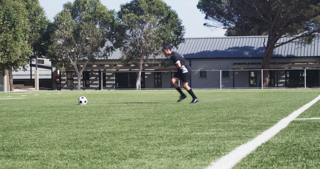 Soccer Player Preparing Kick on Sunny Field
