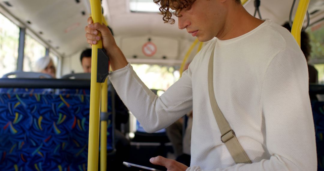 Young Man Using Smartphone on Public Bus - Free Images, Stock Photos and Pictures on Pikwizard.com