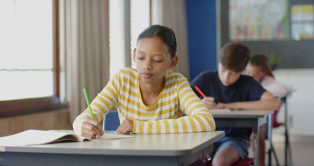 Focused Student in Classroom Writing Notes