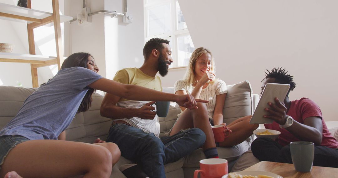 Diverse Group of Friends Relaxing Offortable Sofa with Snacks