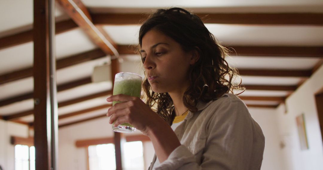 Woman Drinking Healthy Green Smoothie at Home - Free Images, Stock Photos and Pictures on Pikwizard.com