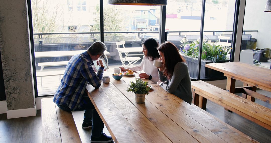 Coworkers Enjoying Break with Coffee and Conversations in Modern Office