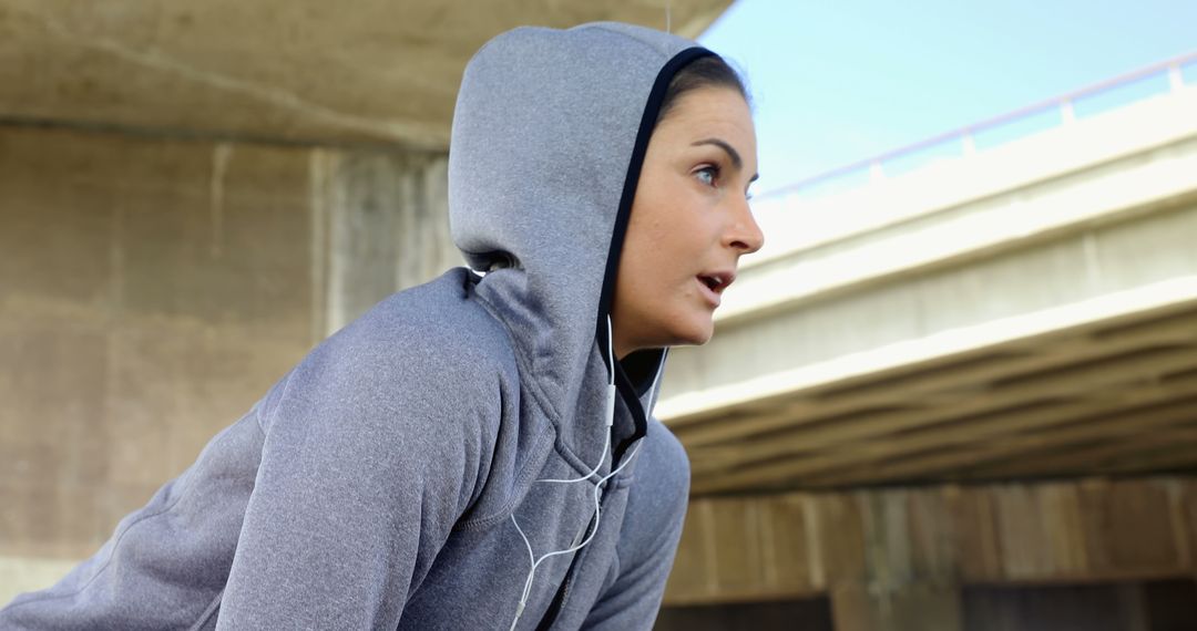 Young Fitness Woman in Hoodie Taking a Break During Outdoor Workout - Free Images, Stock Photos and Pictures on Pikwizard.com