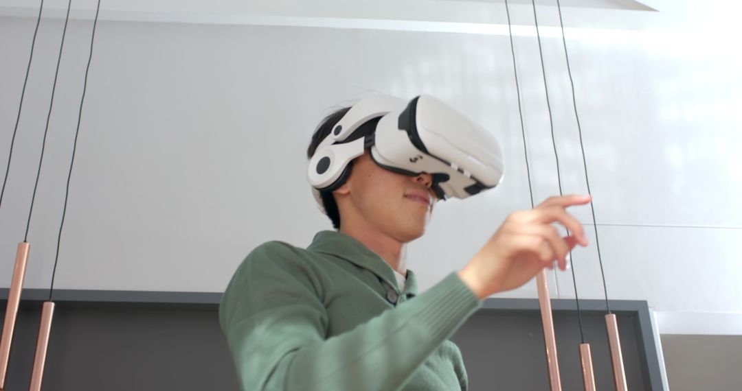 Young Man Exploring Virtual Reality in Modern Interior Space