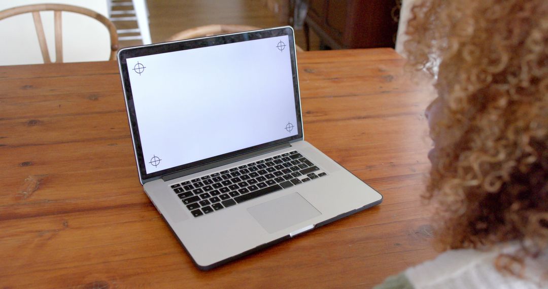 African American Woman Using Laptop with Blank Screen at Home