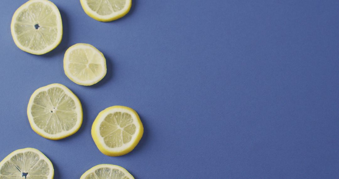 Image of slices of lemon lying on blue background with copy space - Free Images, Stock Photos and Pictures on Pikwizard.com