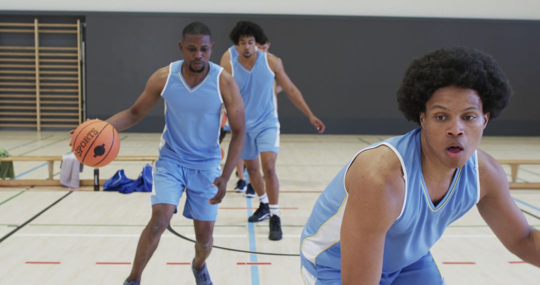 Basketball Players Practicing Indoors in Blue Jerseys - Free Images, Stock Photos and Pictures on Pikwizard.com