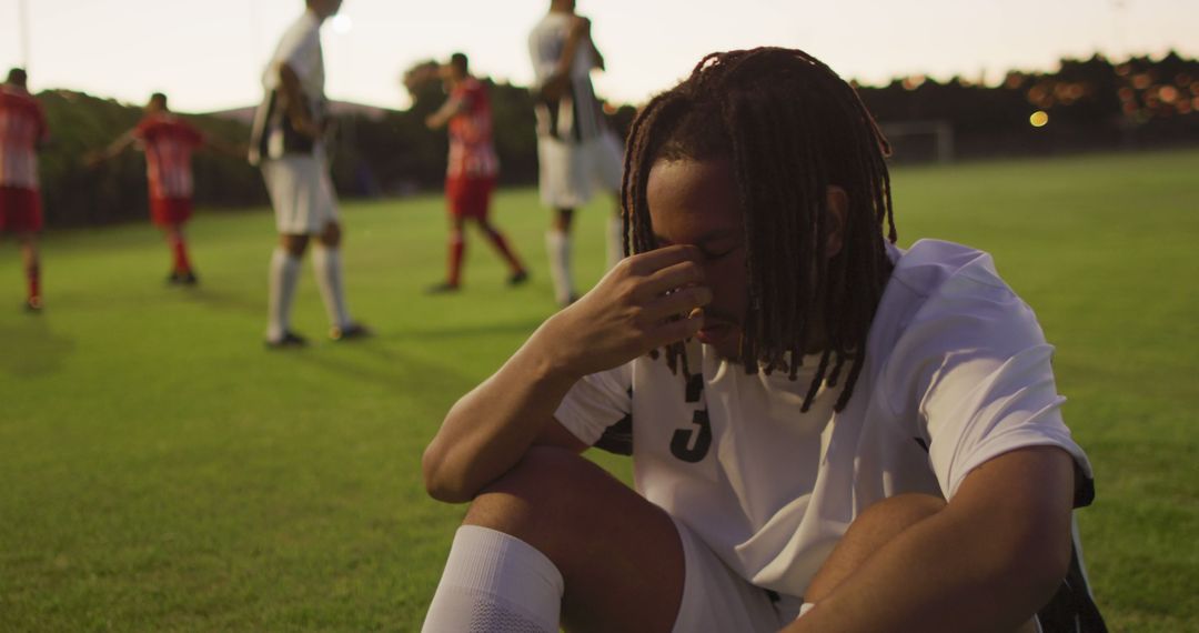 Disappointed Soccer Player Sitting on Field After Loss - Free Images, Stock Photos and Pictures on Pikwizard.com