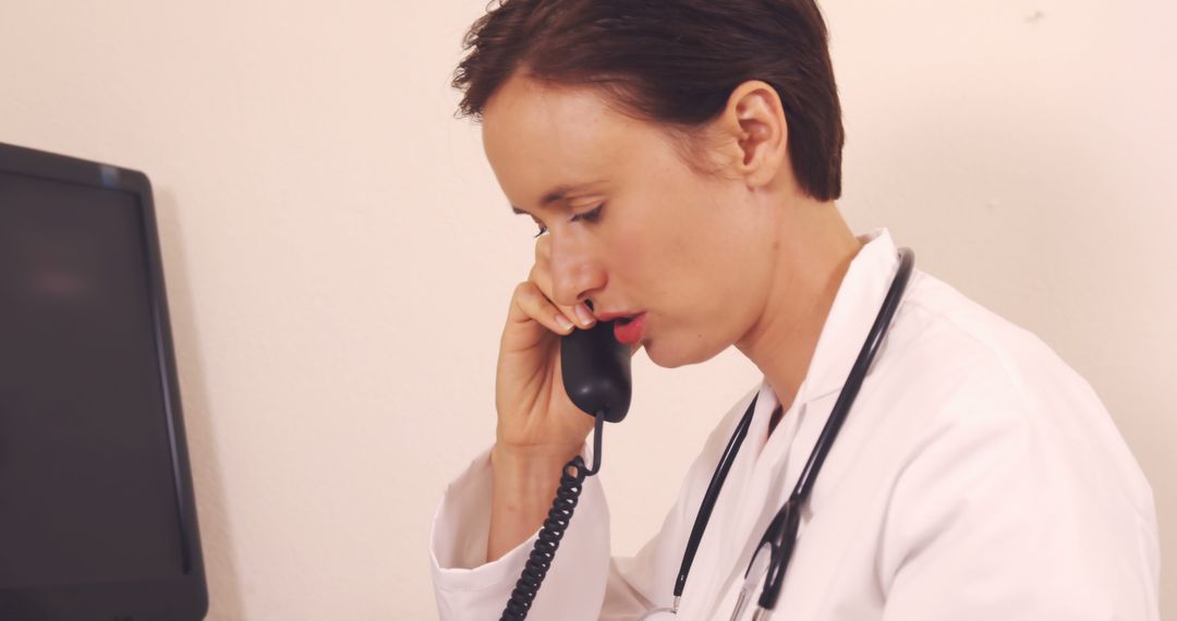 Female Doctor Discussing Medical Case on Phone in Clinic - Free Images, Stock Photos and Pictures on Pikwizard.com