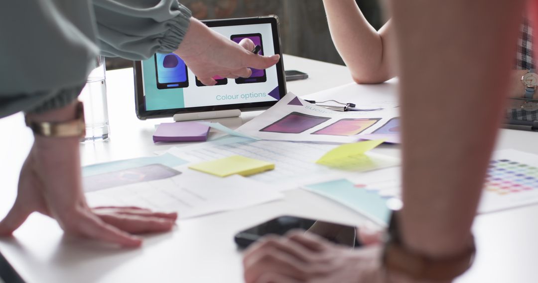 Collaborative Team Discussing Mobile App Design with Color Samples