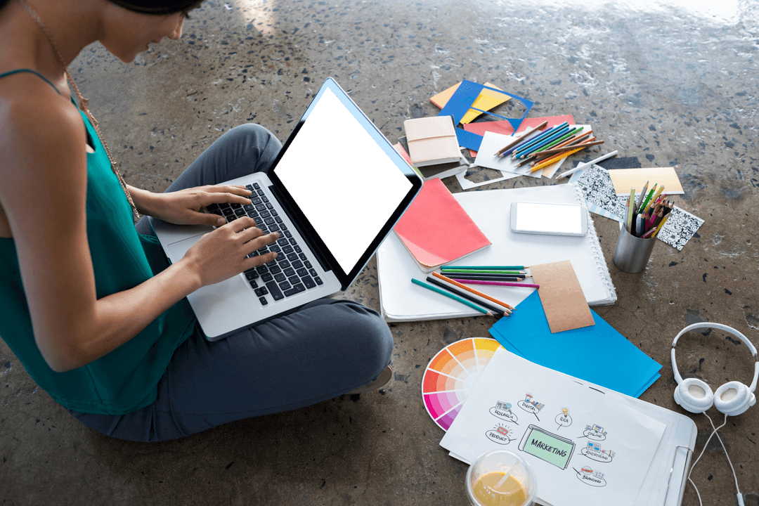 Creative Executive Working with Laptop and Art Supplies on Transparent Floor