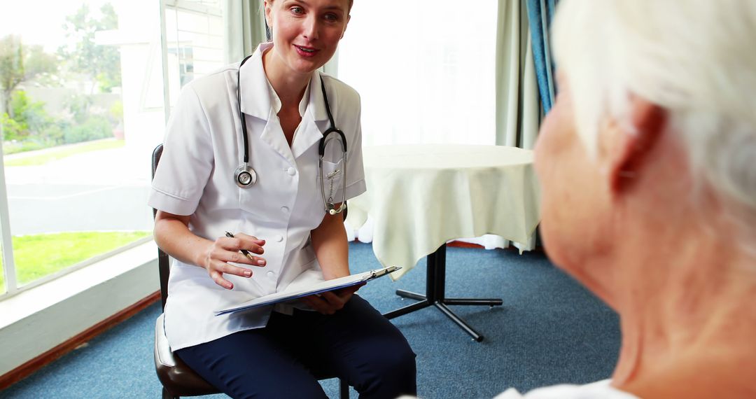 Professional nurse caring for senior patient indoors, smiling confidently - Free Images, Stock Photos and Pictures on Pikwizard.com