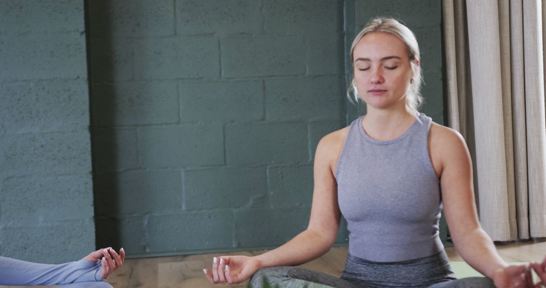 Young Woman Meditating in Relaxed Indoor Environment - Free Images, Stock Photos and Pictures on Pikwizard.com