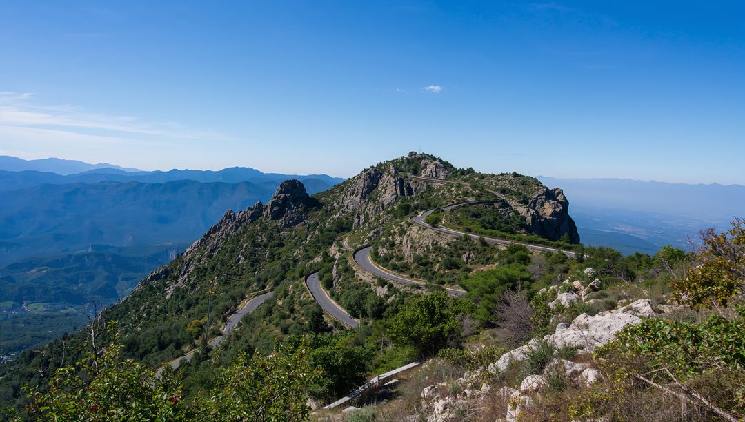 Scenic Mountain Pass with Serpentine Road and Rock Formations