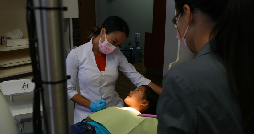 Female Dentist Treating Young Patient in Dental Office - Free Images, Stock Photos and Pictures on Pikwizard.com