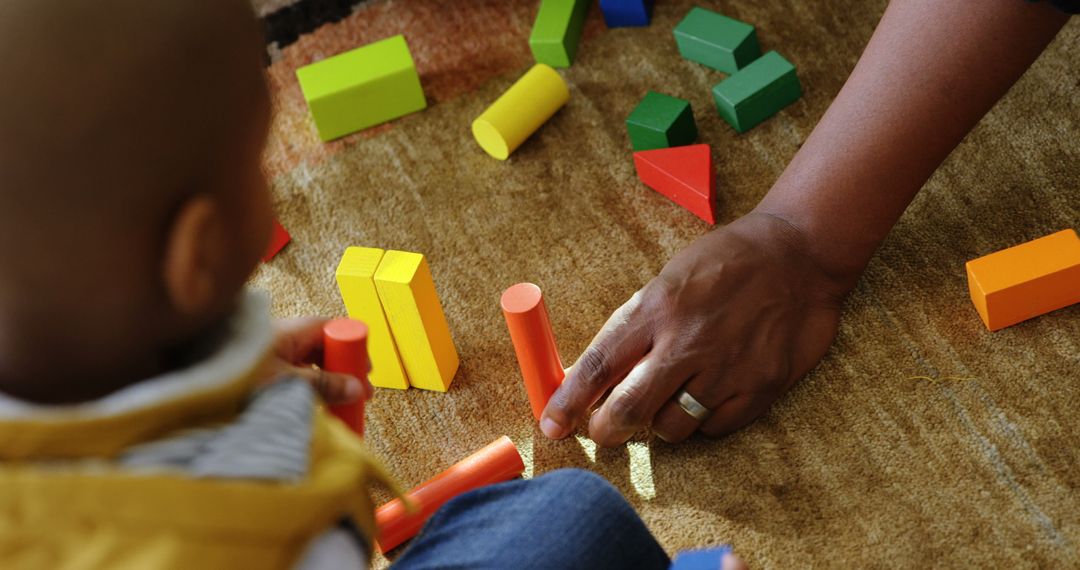 Father and Son Engaging in Play with Colorful Building Blocks at Home