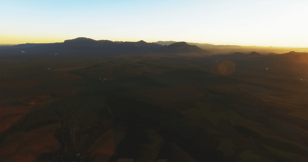 Tranquil Transparent Hazy Sunset Reflections Over Verdant Field