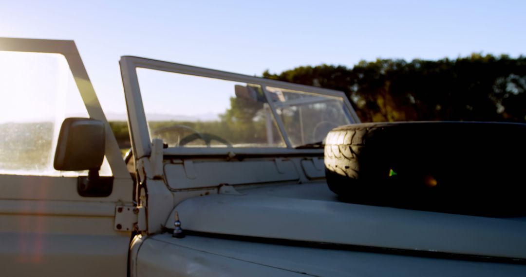 Vintage Convertible Jeep With Spare Tire at Sunset - Free Images, Stock Photos and Pictures on Pikwizard.com