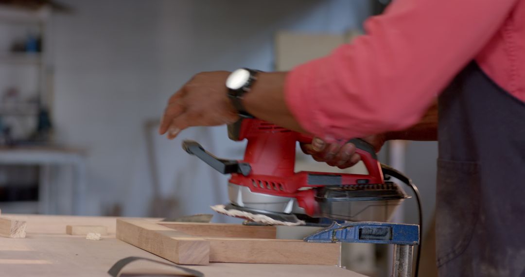 Craftsman Sanding Wood Plank at Carpentry Workshop
