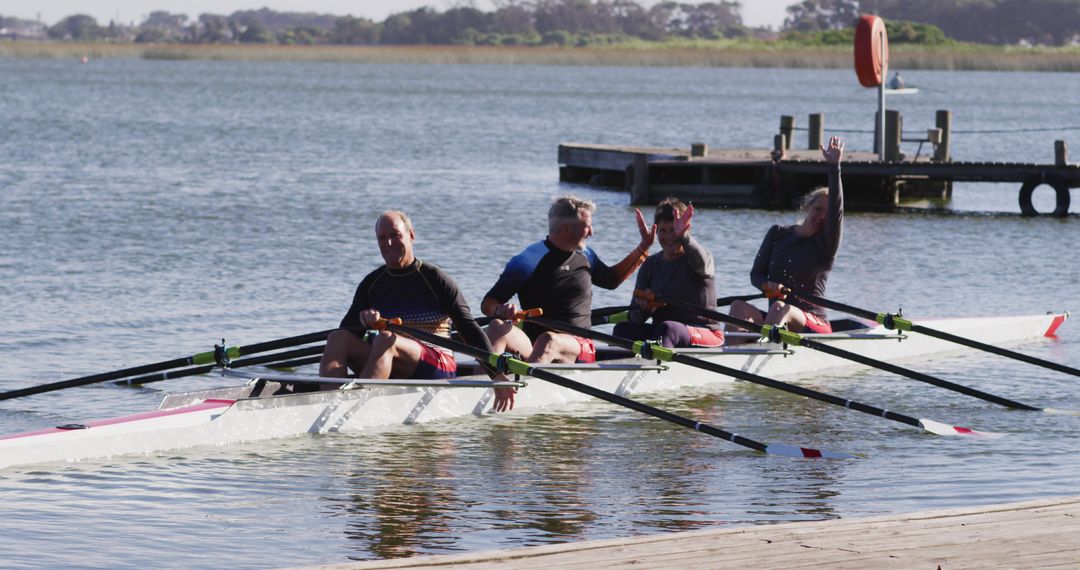 Rowers Celebrating Teamwork on Calm Lake - Free Images, Stock Photos and Pictures on Pikwizard.com