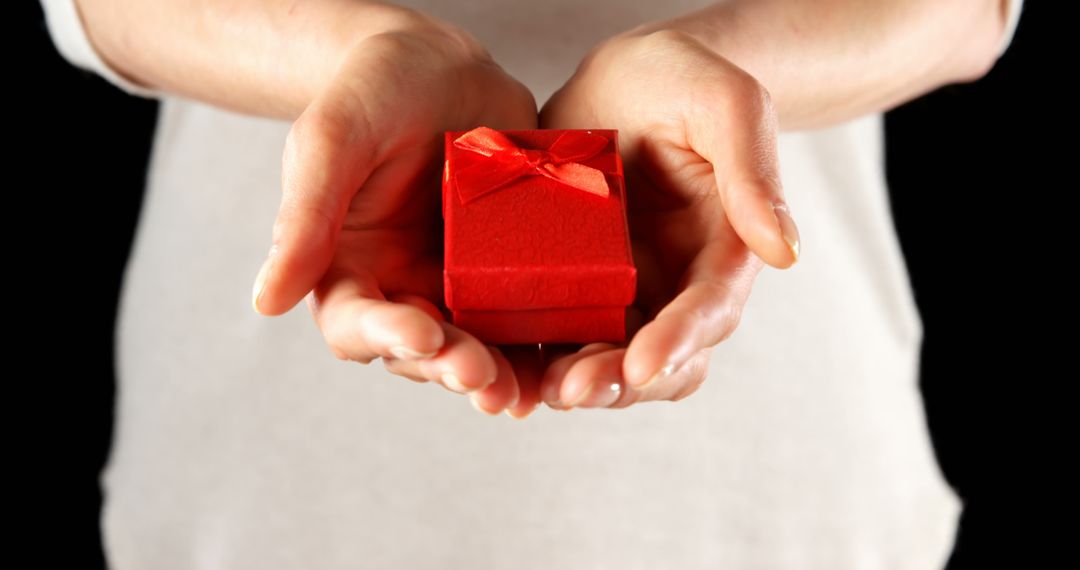 Close-up of Hands Holding Small Red Gift Box with Ribbon - Free Images, Stock Photos and Pictures on Pikwizard.com