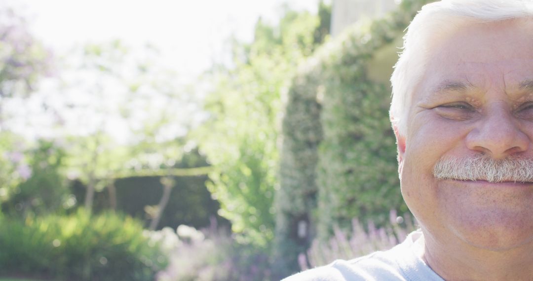 Close-up of Happy Senior Man Smiling in Sunny Garden - Free Images, Stock Photos and Pictures on Pikwizard.com