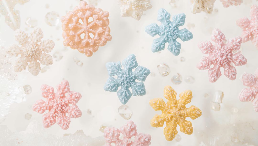 Sparkling Pastel Snowflake Candies Floating on Frosted Surface with Sugar Crystals