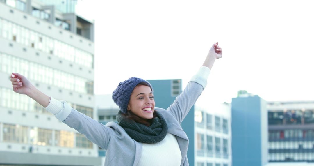 Excited Woman with Raised Arms Outdoors in City - Free Images, Stock Photos and Pictures on Pikwizard.com