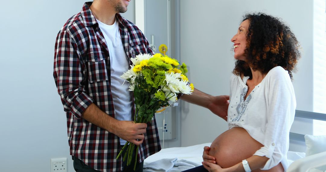 Couple Celebrating Pregnancy in Hospital with Flowers - Free Images, Stock Photos and Pictures on Pikwizard.com