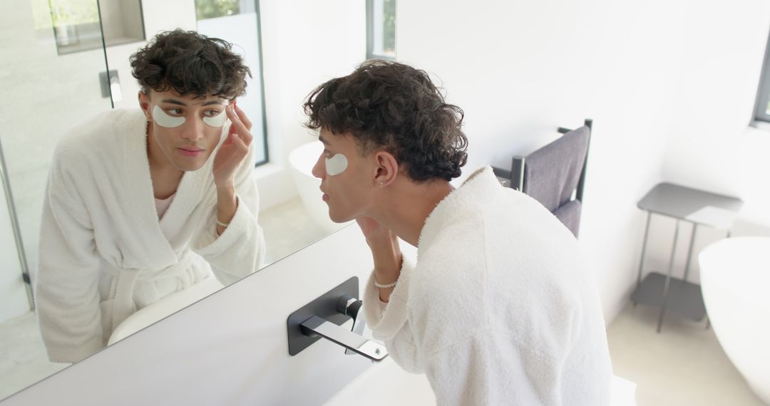 Man Applying Under-Eye Gel Patches for Refreshing Skin Care Routine