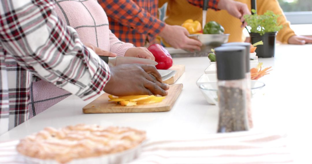 Group Chopping Vegetables on Bright Kitchen Counter for Cooking Class and Meal Prep