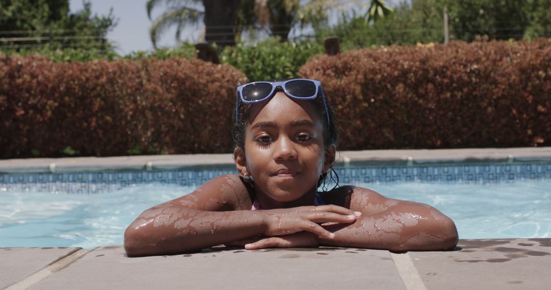 Biracial Girl Enjoying the Sun by the Poolside - Free Images, Stock Photos and Pictures on Pikwizard.com