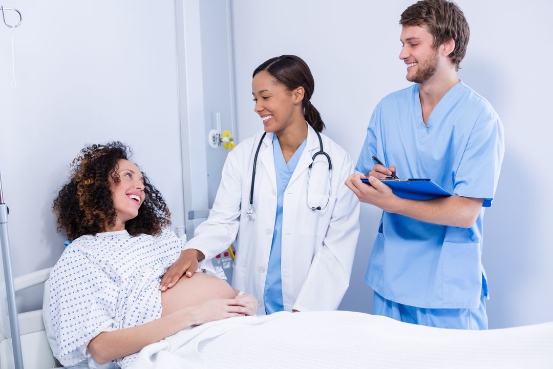 Doctors interacting with pregnant woman in ward - Free Images, Stock Photos and Pictures on Pikwizard.com