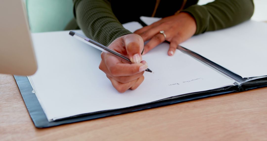 Close-up of Person Writing Notes on Paper at Desk - Free Images, Stock Photos and Pictures on Pikwizard.com