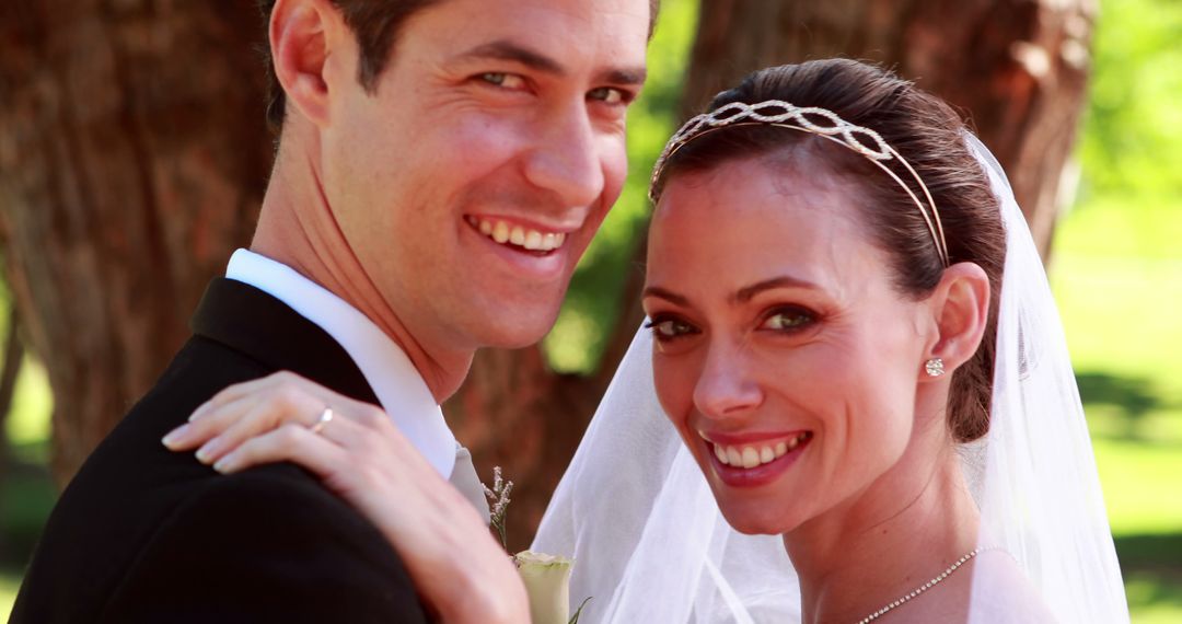 Smiling Bride and Groom Embracing Outdoors on Wedding Day - Free Images, Stock Photos and Pictures on Pikwizard.com