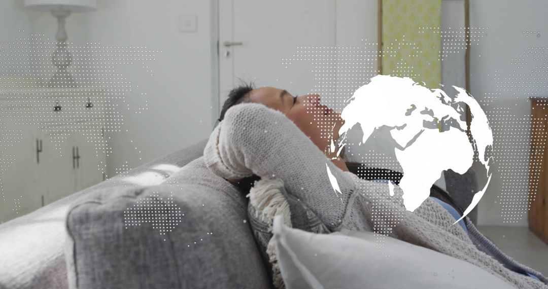 Relaxing Asian Man Reclining on Sofa with Global Map Overlay in Minimalist Living Room