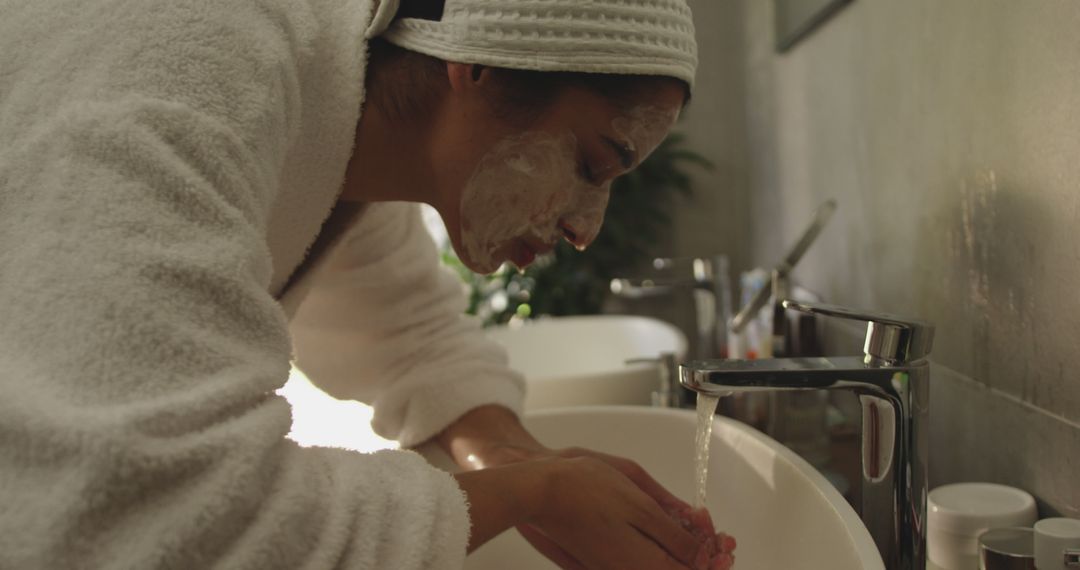 Woman Washing Face with Facial Cleanser in Modern Bathroom - Free Images, Stock Photos and Pictures on Pikwizard.com