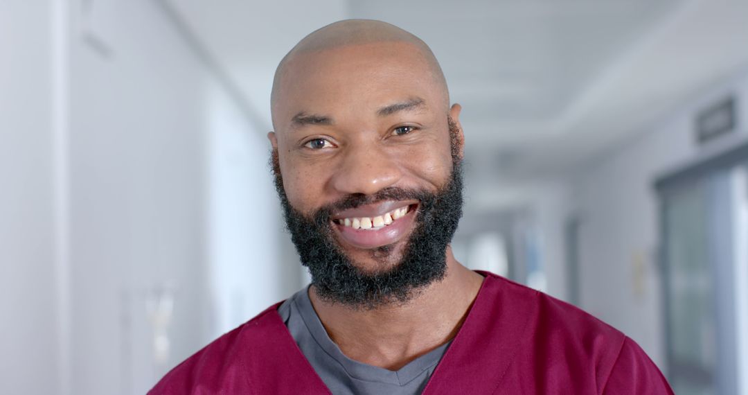 Smiling Male Nurse in Hospital Corridor - Free Images, Stock Photos and Pictures on Pikwizard.com