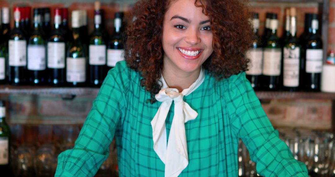 Smiling Bartender in Cozy Pub with Wine Bottles