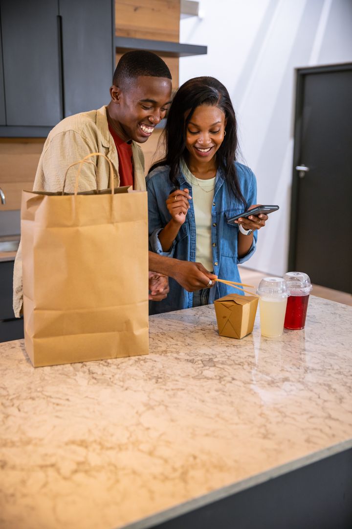Couple Enjoying Takeout at Kitchen Island
