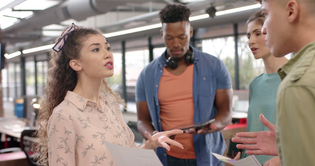 Diverse Team Collaborating on Office Project with Digital Devices