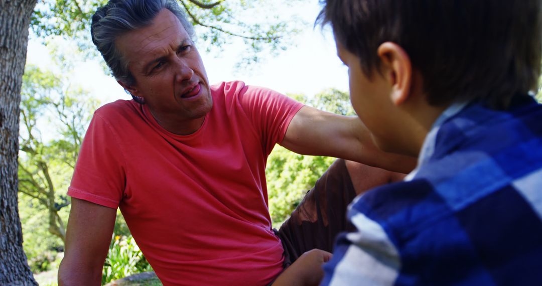 Father and Son Having a Serious Conversation Outdoors in Nature - Free Images, Stock Photos and Pictures on Pikwizard.com