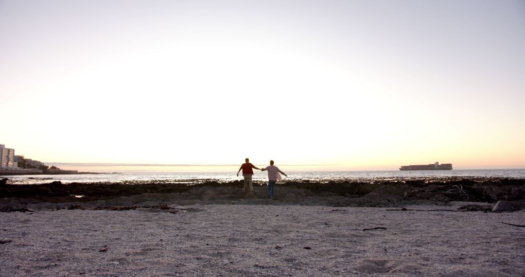 Young Friends Enjoying Beautiful Sunset at the Beach - Free Images, Stock Photos and Pictures on Pikwizard.com