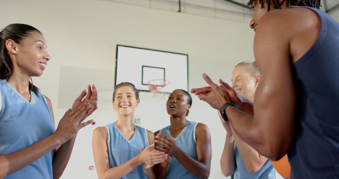 Diverse Female Basketball Team in Motivational Huddle