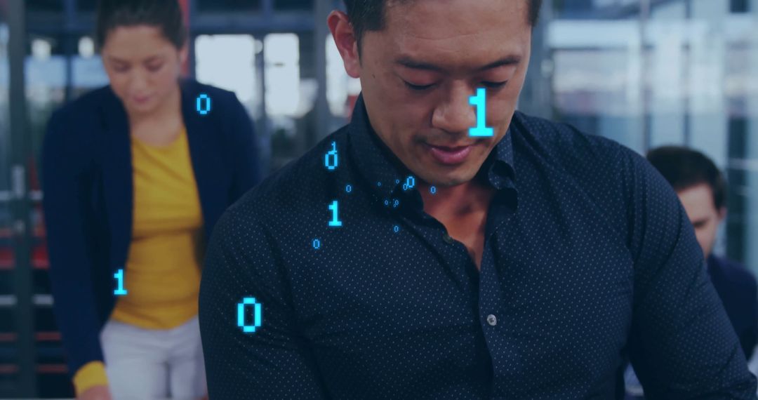 Asian Man Working with Binary Data at Office Workstation