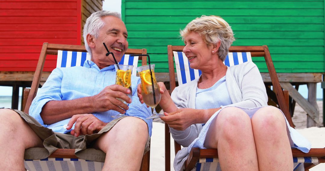 Senior Couple Relaxing on Beach Chairs with Refreshing Drinks - Free Images, Stock Photos and Pictures on Pikwizard.com