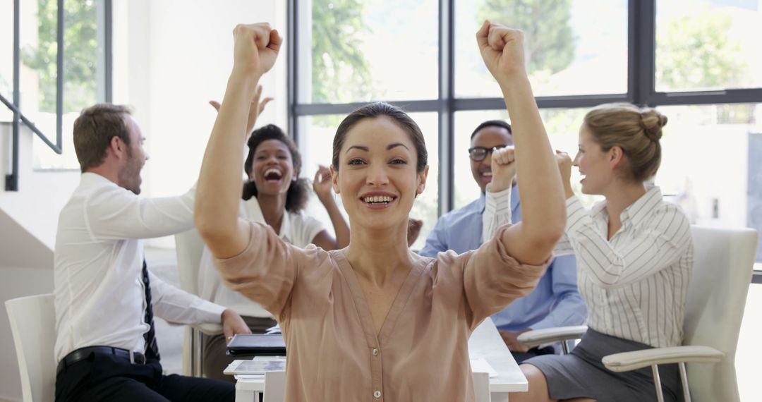 Successful Business Team Celebrating Victory with Raised Fists - Free Images, Stock Photos and Pictures on Pikwizard.com