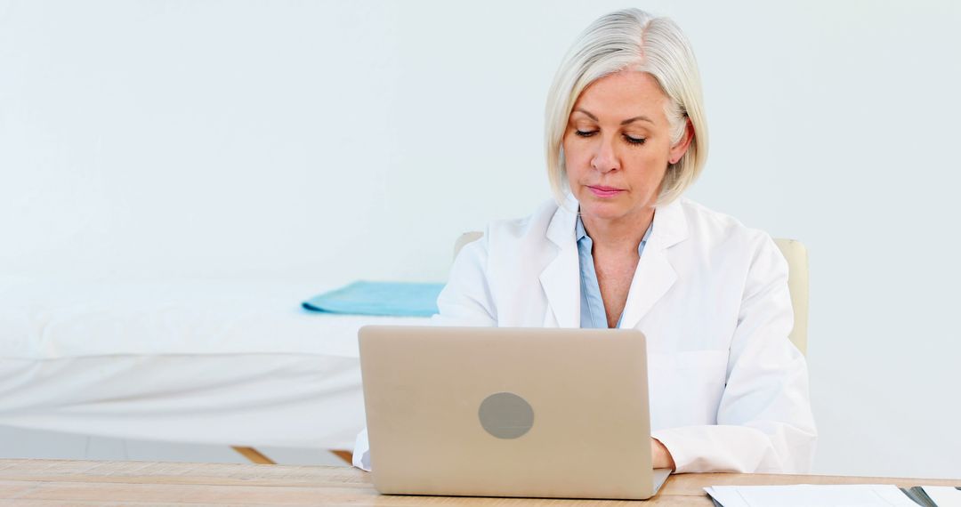 Senior Female Doctor Using Laptop in Office - Free Images, Stock Photos and Pictures on Pikwizard.com